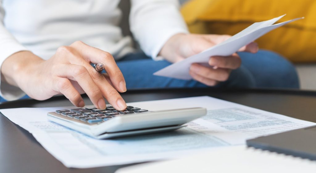 Woman looking at her property tax bill, determining Texas property tax rates