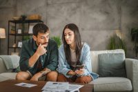 Lower Monthly Mortgage Payment; couple stressing over mortgage payments, financial planning and budgeting