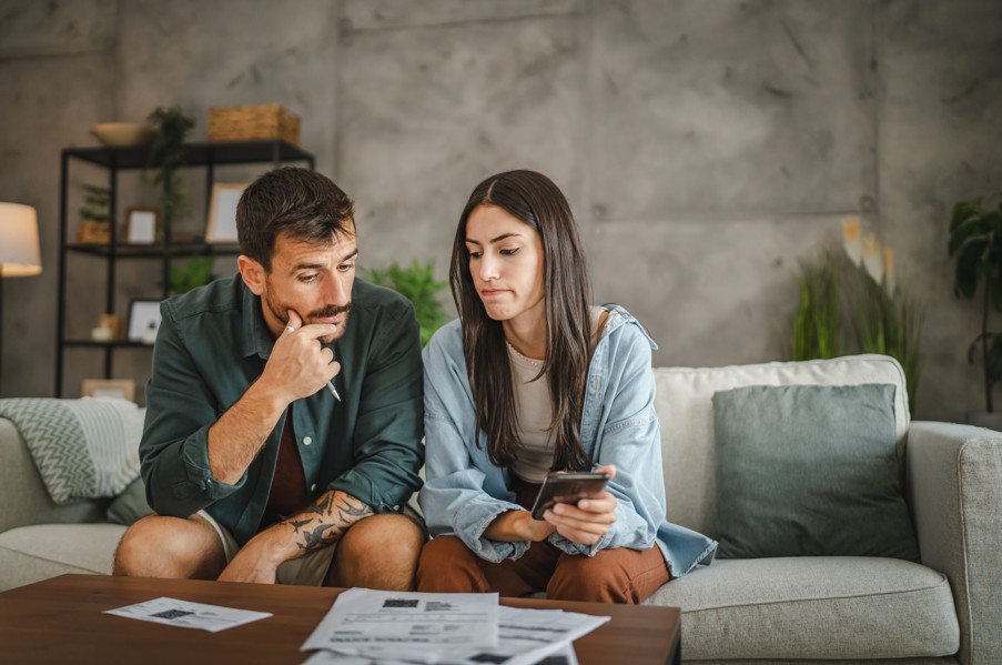 Lower Monthly Mortgage Payment Lower Monthly Mortgage Payment; couple stressing over mortgage payments, financial planning and budgeting