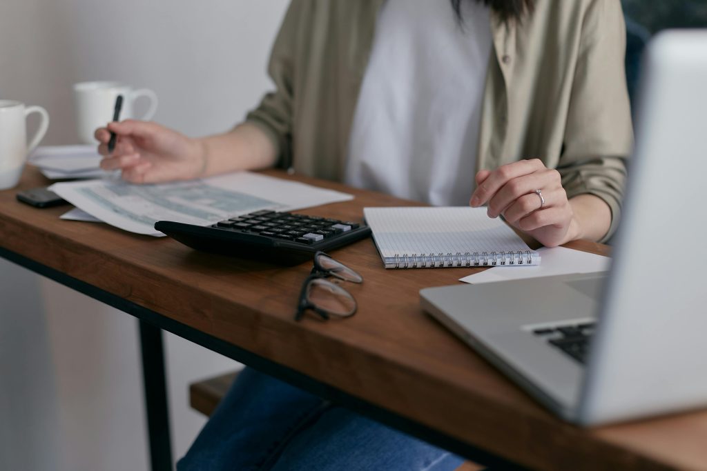pexels-mikhail-nilov-6963857 Homeowner calculating taxes and ways to achieve a lower tax bill