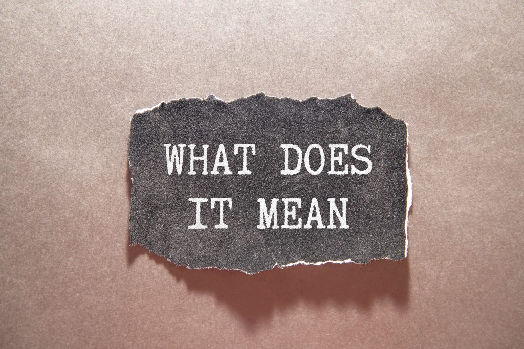 What does it mean symbol. Concept words 'what does it mean' on wooden blocks, discussing property tax protest results