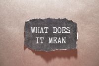 What does it mean symbol. Concept words 'what does it mean' on wooden blocks, discussing property tax protest results