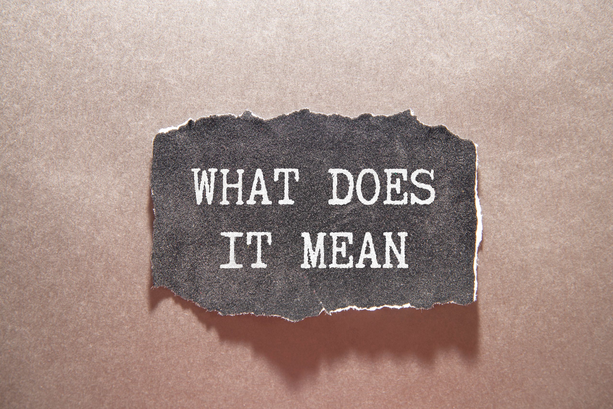 What does it mean symbol. Concept words 'what does it mean' on wooden blocks, discussing property tax protest results