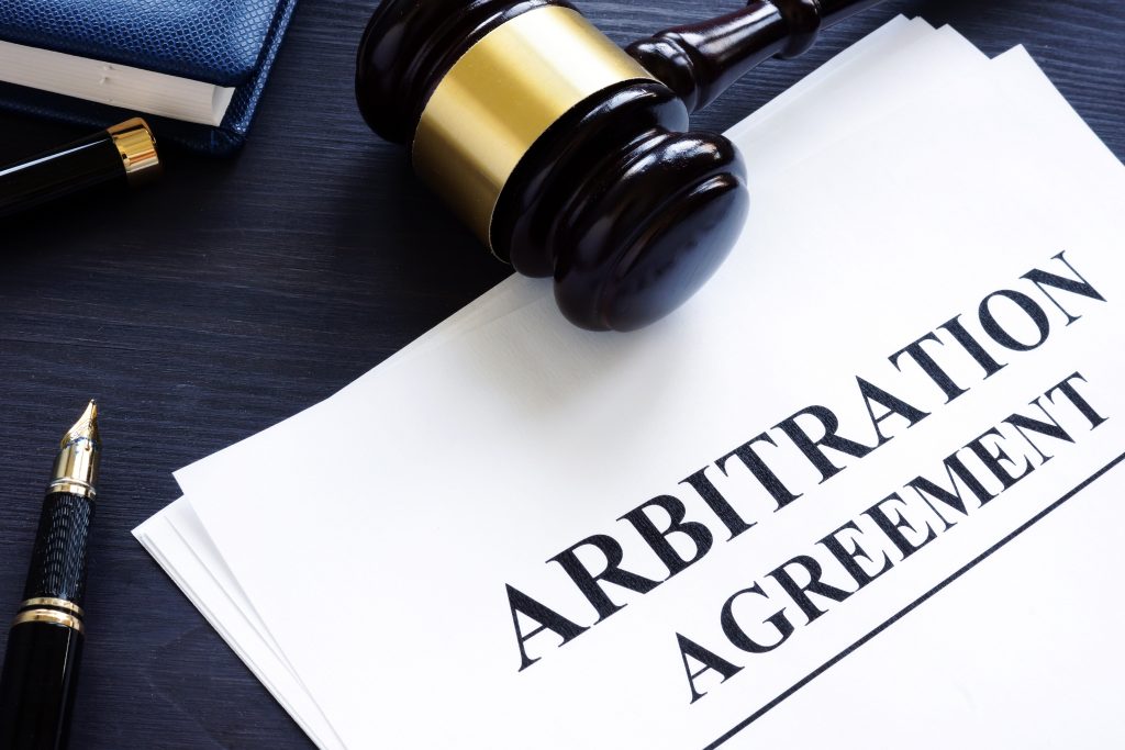 Arbitration agreement and gavel on a desk. Arbitration agreement and gavel on a desk; texas property tax arbitration